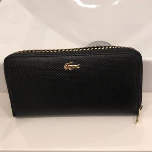 Womens matte pique zip wallet. Excellent condition. Black. Never worn. Lacoste.